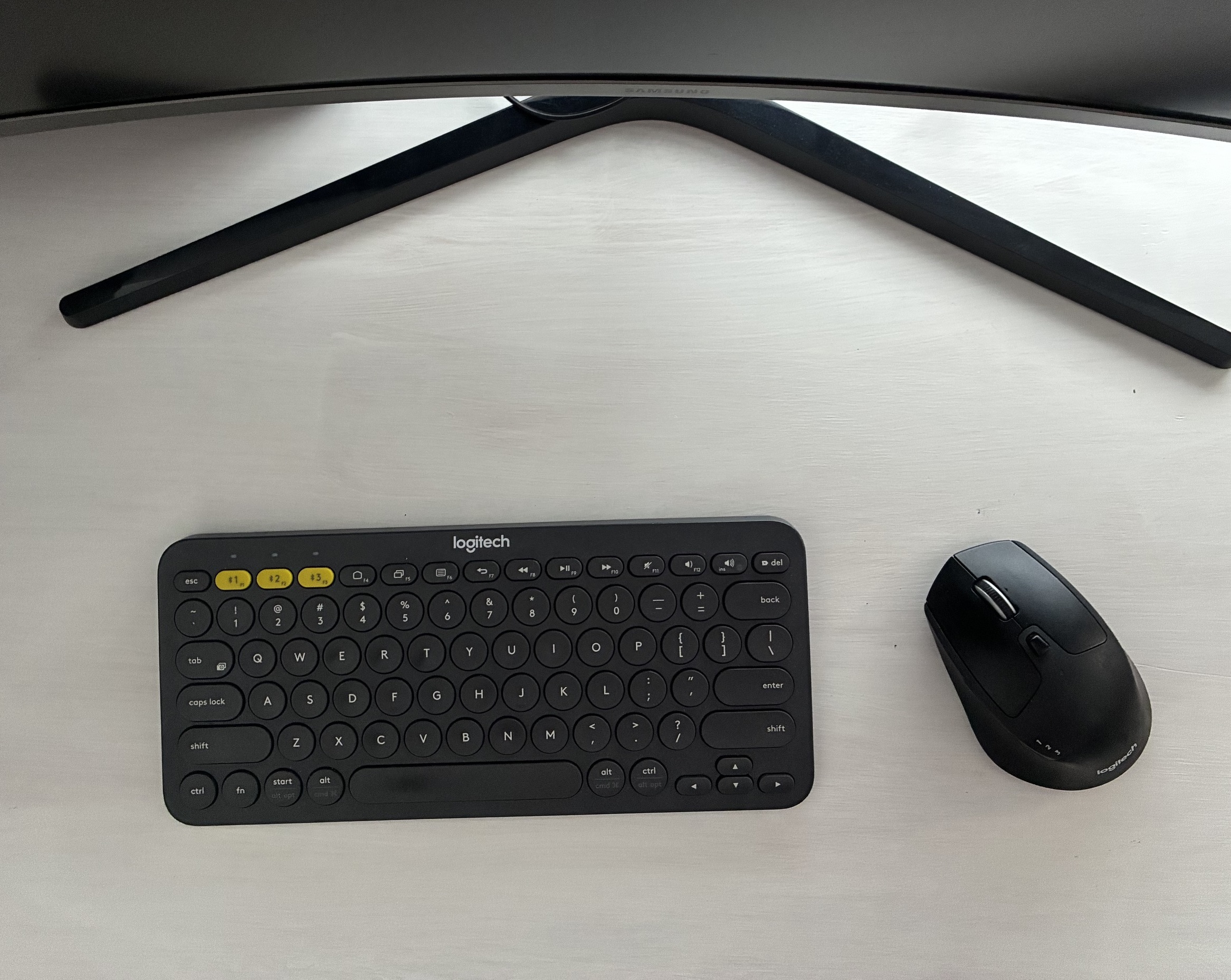 Logitech Pebble Keys 2 K380s keyboard and M720 Triathlon mouse on a desk